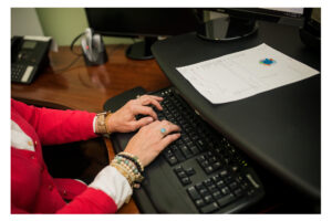 Woman typing on a keyboard in an office